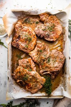 pork chops with herbs and seasoning on a cutting board