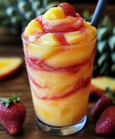 a glass filled with fruit on top of a wooden table