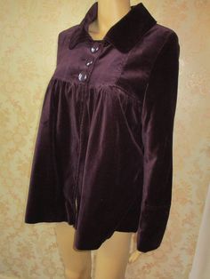 "Velvet jacket in deep purple with three large buttons at the top to close.  This has a collar and small pleats at the bust.  Good condition. Bust flat;  16\" Inside arm;  18\" Length;  29\"" Vintage Long Sleeve Purple Blazer, Vintage Purple Long Sleeve Blazer, Vintage Outerwear With Button Closure For Party, Winter Velvet Outerwear With Button Closure, Vintage Purple Blazer For Fall, Vintage Party Outerwear With Button Closure, Purple Long Sleeve Blazer With Buttons, Vintage Purple Outerwear For Fall, Vintage Velvet Long Sleeve Blazer