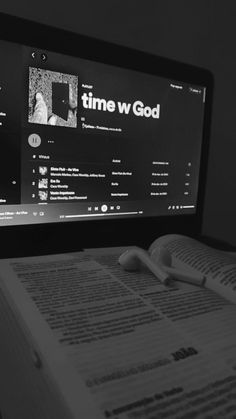 an open book sitting in front of a computer screen with the word time w god on it