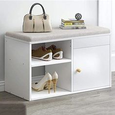 a white shoe cabinet with shoes and handbag on the top shelf next to it