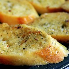 slices of garlic bread sitting on top of a pan