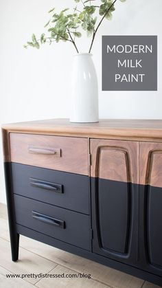 a vase with flowers on top of a black and white dresser next to a sign that says modern milk paint