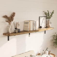 a shelf with books and vases on it