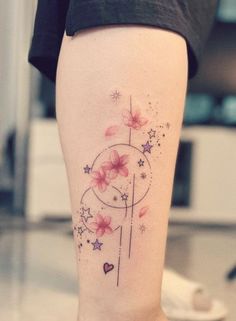 a woman's leg with flowers and stars on it