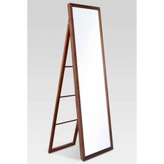 a large mirror sitting on top of a wooden stand