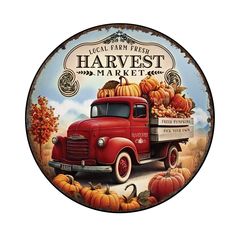 an old red truck with pumpkins on the back in front of a sign that says harvest market