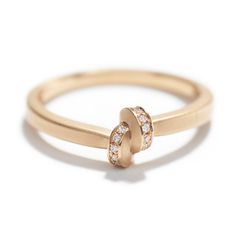 a gold ring with two diamonds on it