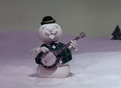 a snowman holding a guitar in the snow