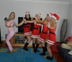 four women dressed up in christmas costumes posing for the camera