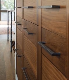 a wooden cabinet with metal handles and drawers