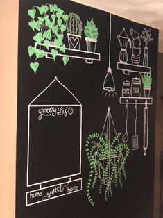 a chalk board with plants and pots on it