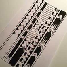 some black and white designs on a piece of paper that is sitting on a table