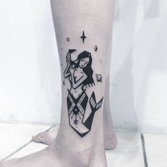 a black and white tattoo on the foot of a woman