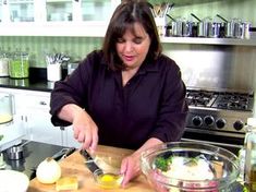 a woman is preparing food in the kitchen