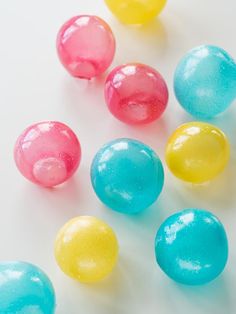 colorful candies are scattered on a white surface