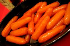 some carrots are in a black bowl on a table