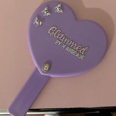 there is a purple heart shaped mirror with butterflies on it and the word grandma written in gold