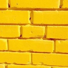 a yellow brick wall is shown in this image