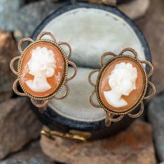 This vintage pair of cameo earrings each feature an open work gold bezel with an oval shell cameo center. The earrings are crafted in 9k yellow gold and are finished with crew-backs for non-pierced ears. 1940s Accessories, Cameo Earrings, Screw Back Earrings, Earrings Vintage, Pierced Ears, Ear Piercings, Screw, Personal Style, Shells