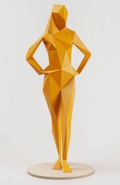 an origami figure is standing on a wooden base with his hands on his hips