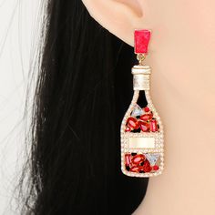 Red Champagne Bottle Rhinestone Earrings Length of the earrings is 6.5cm, width is 2cm. Sugar Boutique - ships from Shawnee, KS Family run boutique - ❤ Shipping and return info - https://www.sugarboutiquekc.com/pages/shipping-returns Red Crystal Metal Party Earrings, Red Metal Crystal Party Earrings, Red Crystal Metal Earrings For Parties, Valentine's Day Party Crystal Earrings, Valentine's Day Party Crystal Metal Earrings, Valentine's Day Crystal Earrings For Party, Red Metal Earrings For Party, Crystal Earrings For Valentine's Party, Red Rhinestone Evening Earrings