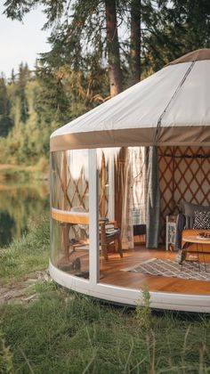 the inside of a yurt is shown with chairs and tables in front of it