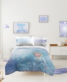 a bed room with a neatly made bed and pictures on the wall