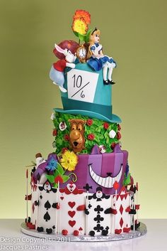 a multi layer cake decorated with an image of a dog and other animals on top