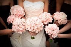 the bridesmaids are holding bouquets of pink roses