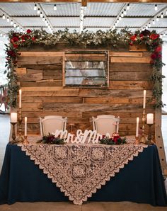 a table with two chairs and candles on it