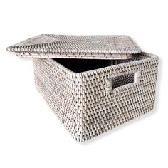 an empty wicker storage box with lid on white background, closeup view from the bottom