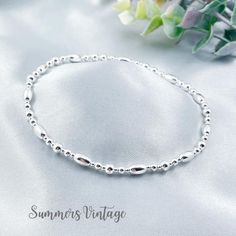 This simple, minimalist beaded anklet, made entirely in .925 sterling silver, makes an elegant and timeless addition to your jewellery collection  The mix of solid sterling silver beads are strung on high quality, strong, professional jewellers' elastic meaning there are no fiddly clasps to deal with, simply roll the anklet over your foot, and onto your ankle  This classic anklet looks stunning as a stand-alone piece or can be worn alongside other anklets to create a more Bohemian style  The ank Silver Minimalist Anklets For Everyday, Silver Elegant Anklets For Everyday Wear, Elegant Silver Anklets For Everyday, Elegant Silver Anklets With Tiny Beads, Minimalist Hypoallergenic Sterling Silver Anklets, Elegant Silver Anklets With Round Beads, Summer Jewellery, Bracelet Summer, Jewellery Pouch