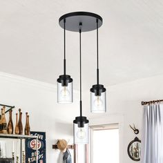 three lights hanging from the ceiling in a kitchen