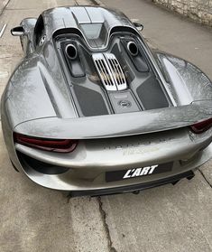 a silver sports car is parked on the street