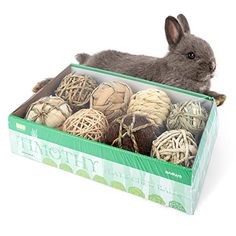 a rabbit sitting in a box filled with yarn