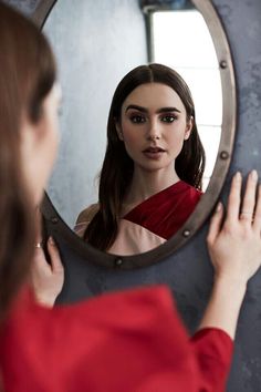 a woman looking at herself in the mirror