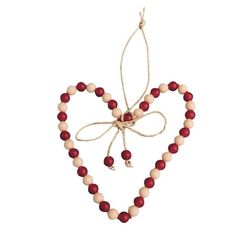 a heart shaped ornament with red beads and a white beaded necklace hanging from it's side