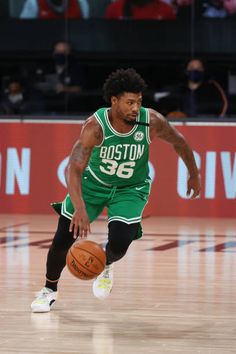 a basketball player dribbling the ball during a game in boston, ma on march 28