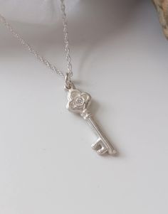 This key pendant has been handmade using fine silver and features a trefoil shaped top set with a 2mm sparkly cubic zirconia. This pendant measures 9mm across at its widest point and is approx. 25mm in length. This pendant has been hallmarked by the London Assay Office. It is available on a 16, 18" or 20" sterling silver rope chain. Have a look at my necklace size guides in the product pictures to see how these sizes might fit you. Keys are one of the oldest lucky charm symbols. The giving of a Silver Necklace With Two Keys For Gift, Silver Key Necklace, Silver Key, Luck Charm, 21st Birthday Gifts, Key Necklace, Keepsake Jewelry, Luck Charms, Key Pendant