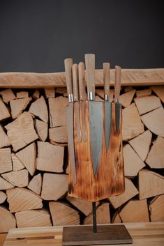 a knife holder made out of wood with knives sticking out of it's sides