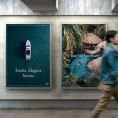 a man walking past two posters on the wall