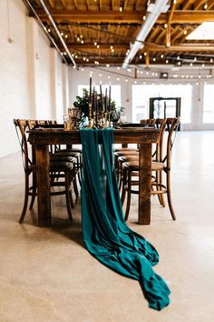 the table is set with candles, flowers and greenery for an elegant wedding reception