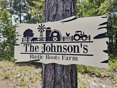 a wooden sign that says the johnson's rustic roots farm in front of a tree