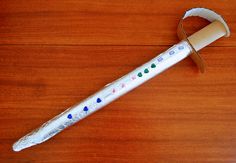 a paper mache with colored dots on it sitting on top of a wooden table