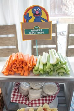 an assortment of vegetables and dips on a table with a sign that says groveer's super foods