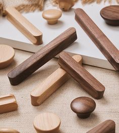 several wooden pegs are laying on the floor next to some other wood toys and decorations