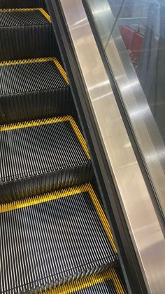 an escalator with yellow lines going down it