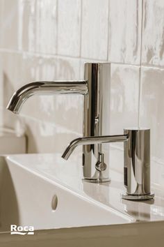 a chrome faucet sitting on top of a white sink