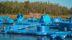 an inflatable water park with people playing on it